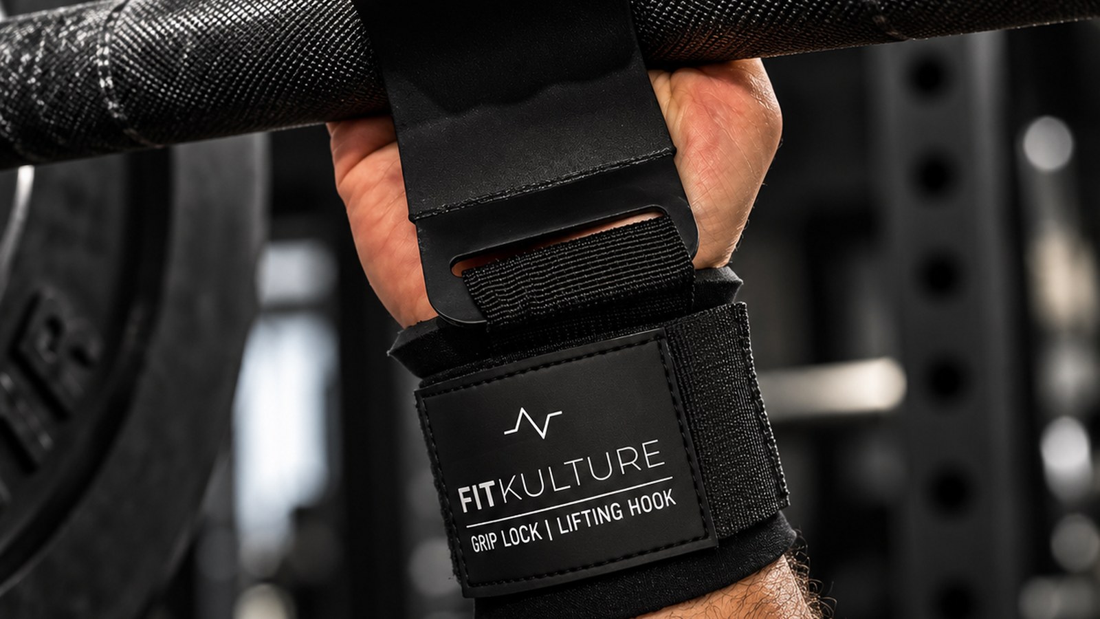 Lifter wearing FIT KULTURE Grip Lock Lifting Hooks with the hook resting on a barbell
